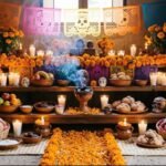 Altar de Día de Muertos con flores de cempasúchil, velas, pan de muerto y papel picado